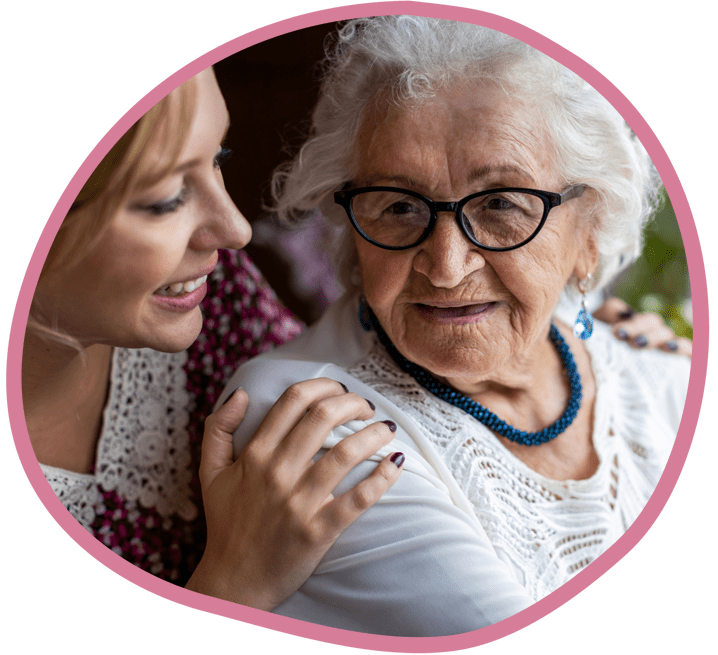 Female carer and female client smiling with each other