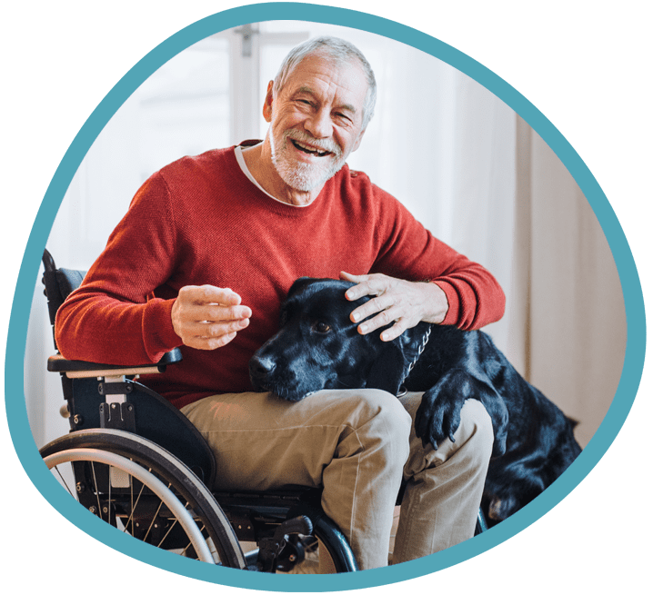 Male client with his black labrador in a wheelchair