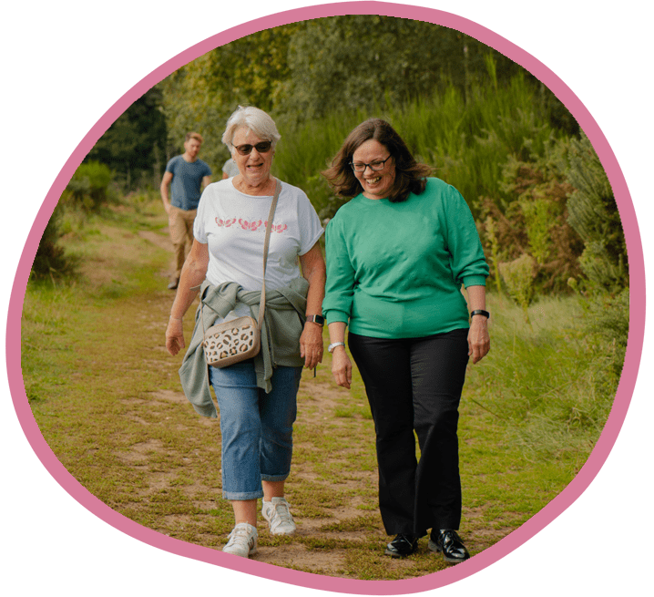 Female carer and female client outsite on a walk together