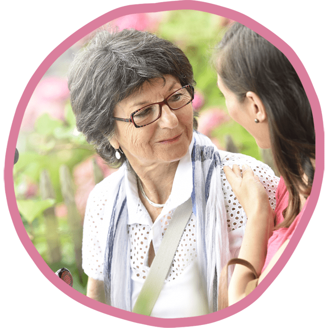 Female client and female carer sat outside in the garden