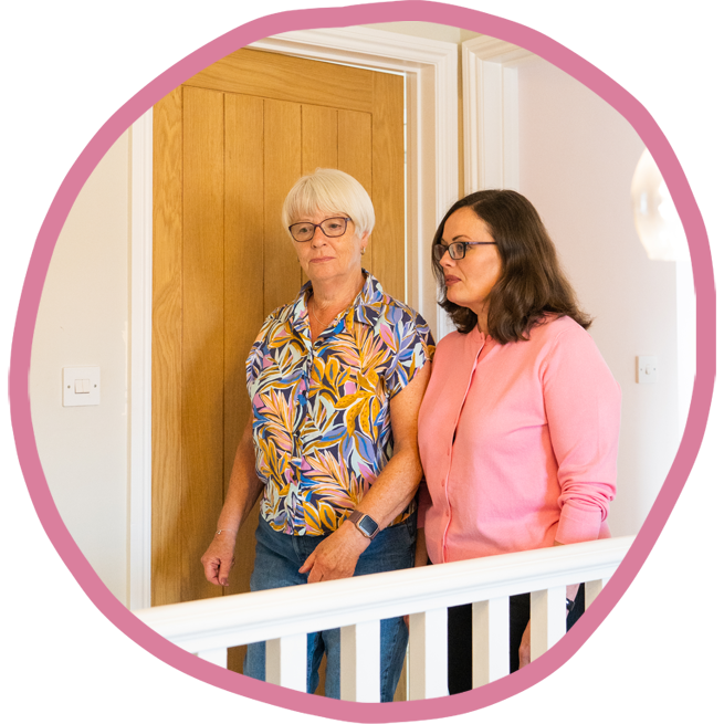 Female carer and female client walking together