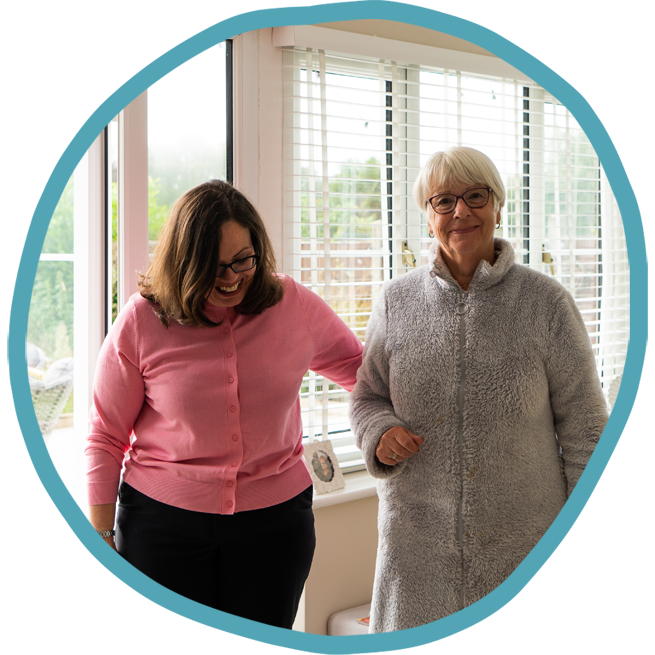 Female carer and female client walking together