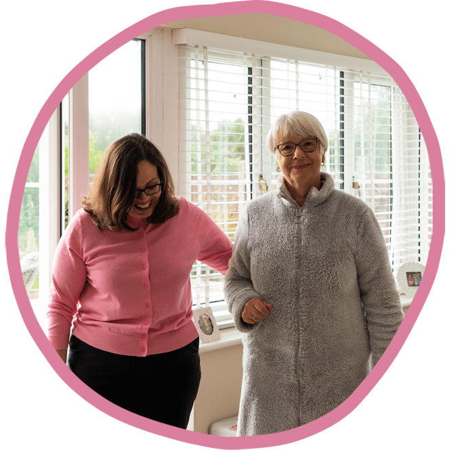 Female carer and female client walking together